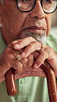 Senior man, hands and thinking with cane in retirement home for grief, alzheimer or nostalgia with memory. Lonely, elderly person and thoughtful with walking stick for contemplation and mental health