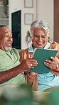 Senior, couple and laughing with tablet on sofa for funny online game, social media meme or bonding. Connection, happy people or relax in home with digital app for streaming comedy show in retirement