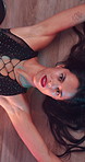 Sexy stripper, erotic and woman on floor for art, performance or lingerie above. Pole dancer, sensual and person in nightclub for exotic entertainment, burlesque show and face with top view on stage