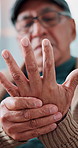 Senior man, massage and pain in hands with tension, arthritis complication and poor blood circulation in home. Elderly person, closeup and sore with joint inflammation, osteoporosis and carpal tunnel