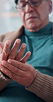 Elderly man, massage and pain in hands with tension, arthritis complication and poor blood circulation in home. Senior person, fingers and sore with joint inflammation, osteoporosis and carpal tunnel