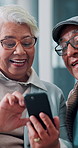 Home, smartphone and old couple with smile, love and bonding together with social media. Apartment, happy senior man and mature woman in lounge, cellphone and funny with online comedy, joke and humor