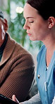 Nurse, tablet and senior man in home for consultation, help and support in rehabilitation. Patient, retirement and caregiver with technology for medical health records, insurance application or talk