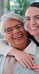 Senior woman, face and caregiver with hug for support, assisted living and care in retirement home. Elderly person, nurse and laugh in lounge for healthcare, recovery development and consultation