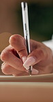 Person, hands and writing with pen on book for diary notes, schedule planning or reminder. Closeup, journalist or copywriter with words, journal or author for literature, letter or private invitation