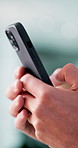Person, typing and phone in hands for contact, email draft and business research in office. Closeup, employee and mobile with interaction for social media comment, forum discussion and networking