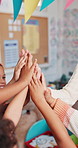 Children, hands or teacher with high five for teamwork, unity or childhood development at school. Closeup, group or kids with educator for education, fun learning or community in youth or classroom
