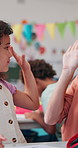 Girl, student or high five with teacher for good job, well done or learning success in classroom. Child, kid or learner with educator, smile or touch for education, motivation or support at school