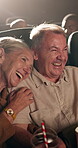 Laugh, drink and senior couple in cinema for movie on date together for anniversary celebration. Love, laughing and elderly woman with man cuddle for watching comedy film at theater with beverage.