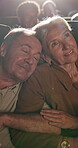 Happy, sleeping and senior couple in cinema for movie on date together for anniversary celebration. Love, care and elderly woman with man cuddle for watching film at theater with nap for fatigue.