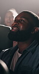 Happy man, laughing or watching with movie at cinema for comedy show, humor or entertainment. Customer, male person or smile with funny joke or comic for performance or motion picture in dark theater