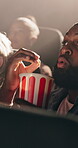 Shock, popcorn and man with movie in theater for horror cinema production, entertainment and scared audience. People, surprise and snack for spooky film screening, auditorium show and event at night