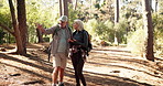 Phone, hiking and couple outdoor for direction, destination discussion or lost. Mobile, senior man and woman in forest for trekking, check map or pointing for navigation app with location for travel