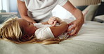 Home, parent and child with tickle for playing, laughing and bonding together in loving relationship. Bedroom, mother and girl with funny game for connection, childhood activity or support with trust