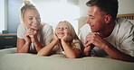 Happy, home and bedroom with parents, girl and bonding together with family, relax and morning. Chilling, mother and father on bed, daughter and smile with rest, support and people with love