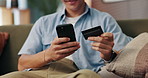 Man, hands and phone with credit card for payment, online shopping or ecommerce at home. Closeup, male person or shopper with debit on mobile smartphone for banking app or remote purchase at house