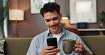 Sofa, man and coffee with smartphone for chat, reading message and text from online contact. Home, male person and social media with mobile for application, dating website and tea drink in lounge