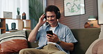 Headphones, dancing and man with phone on sofa in home for chatting, relaxing and listening to music. Audio tech, cellphone and person with networking and streaming album on mobile app in living room