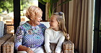 Happy, relax and grandmother with child in home with bonding, love and family time. Smile, conversation and senior woman with girl kid for talking with knowledge together in living room in house.