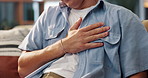 Man, hands and chest pain with heart burn for cardiac arrest, pressure or anxiety on sofa at home. Closeup, male person or injury with ache for bronchitis, lung disease or viral infection at house