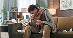 Sick, man and sneeze with tea on sofa for illness recovery, lemon treatment and healing. Cold, person or blanket with honey drink for influenza virus, health benefits and remedy for infection in home