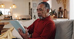 Tablet, typing and relax with old man on sofa for streaming, communication app and retirement. Subscription, contact and chat with senior person in living room at home for reading, search and online