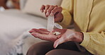 Senior, hands or pill container on sofa for prescription medication, daily routine or arthritis treatment. Healthcare, old person or tablets dosage for wellness supplements or medical disease in home