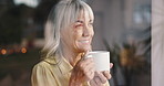 Senior, happy woman and thinking with coffee by window for memory, ambition or dream at home. Elderly, female person or smile in wonder or thought with drink or glass reflection for morning at house