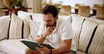 Thinking, tablet and man on sofa in home for relax with decision, idea and choice for stock investment. Living room, online and person on digital tech for trading website, networking and connection