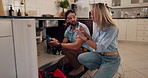 Plumber, repair and handyman with woman in kitchen for maintenance, installation service or renovation. Discussion, inspection and man talking to client with pipe to explain leak or sink problem