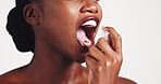 Breathe, spray and oral care with black woman in studio for dental, odor and cosmetics on white background. Smile, mist and model with mouth product, clean and essence for fresh smell and aesthetic