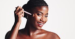 Makeup, face or black woman with brush in studio for cosmetic application on a white background. Portrait, female person or happy model with smile in satisfaction for cosmetology or beauty foundation