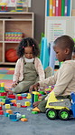 Building blocks, education and children in classroom for play time in morning at preschool. Happy, students and group of kids with cognitive development, skills or growth at elementary academy.