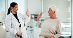 High five, doctor and smile for senior woman, checkup and celebration for positive results and healthcare. Happy, medical professional and gesture for elderly patient in hospital, people and success