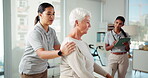 Helping, physiotherapist and senior woman in clinic, rehabilitation or tracking process with tablet. Hospital, healthcare and women with treatment for elderly patient, medical appointment or wellness
