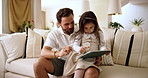 Home, reading and father with child for tablet, support and education story for cognitive development. Couch, talk and dad with girl for digital ebook, learning website and bonding together in house