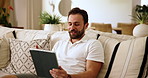 Tablet, video call and man on sofa in home for communication, connectivity or contact. Happy, digital technology and male person talking with virtual conversation on app in living room at apartment.