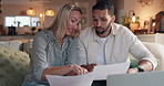 Couple, finance and documents with laptop on sofa at night for mortgage payments, bills or investment. Man, woman or discussion with paperwork on computer for financial planning or invoices at home