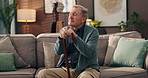 Home, thinking and old man with walking stick, loss and grief with retirement, cane and anxiety. Apartment, pensioner and elderly person on sofa, alzheimer and mental health with nostalgia and memory