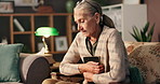 Old woman, photo frame and memory in home with grief, sad or emotions in living room. Pensioner, apartment or elderly person on chair, loss or relax with picture, gratitude or lonely in retirement