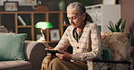 Senior woman, photo frame and memory in home with grief, sad and pensioner in living room. Broken heart, gratitude and elderly person on chair, loss and emotion with picture and lonely in retirement