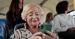 Bus, senior woman and smile with smartphone for communication, travel map and chat with contact. Public transport, elderly person and passenger with mobile for location, commute and message in London