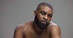 Skincare, beauty and face of black man in studio for glow hygiene and grooming. Shine, self care and cosmetics with portrait of male person on gray background for model, salon and dermatology
