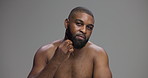 Comb, beauty and beard with face of black man in studio for shower, shampoo and grooming. Hairstyle, self care and cosmetics with person on grey background for barber, cleaning and dermatology