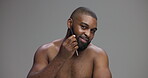 Comb, smile and beard with face of black man in studio for growth, beauty and grooming. Hairstyle, self care and cosmetics with person on grey background for barber, cleaning and dermatology