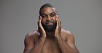 Face, skincare and black man apply cosmetics for treatment, dermatology or think. Moisturizer, cream and happy person with beauty lotion for hydration or natural glow on gray studio background space