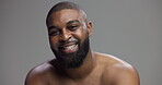 Skincare, black man and face with confidence in studio, hygiene and model with happiness for wellness. Mockup space, male person and smile in portrait for dermatology, cosmetics and gray background