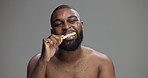 Black man, brushing teeth and smile in studio for dental routine, hygiene and check by background. Person, model and bamboo toothbrush for sustainability, cleaning mouth and oral care for results