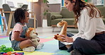 Kindergarten, talking and toys with teacher and girl playing games for development, learning and story. Classroom, wellness therapy and therapist with kid, child student and woman with stuffed animal