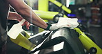 Gym, hands and spray for cleaning equipment, safety or hygiene for maintenance. Man, health or wipe fitness machine with cloth at sports club for disinfection, sanitation and remove bacteria or virus